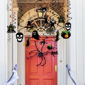 Halloween hanging swirl decorations with bats, ghosts, pumpkins, witches, and skulls above an orange door.