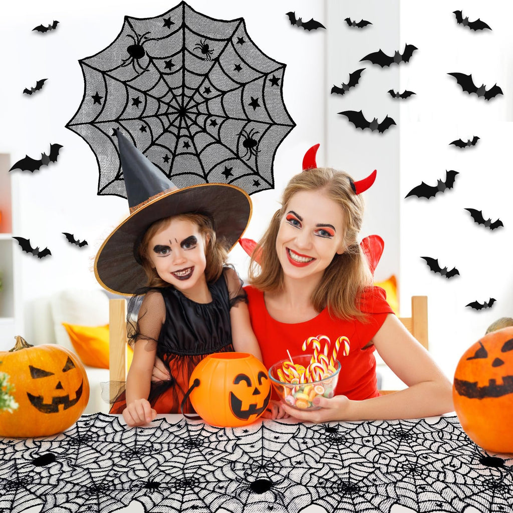 Mother and daughter in Halloween costumes with pumpkins and candy, surrounded by spiderweb and bat decorations.