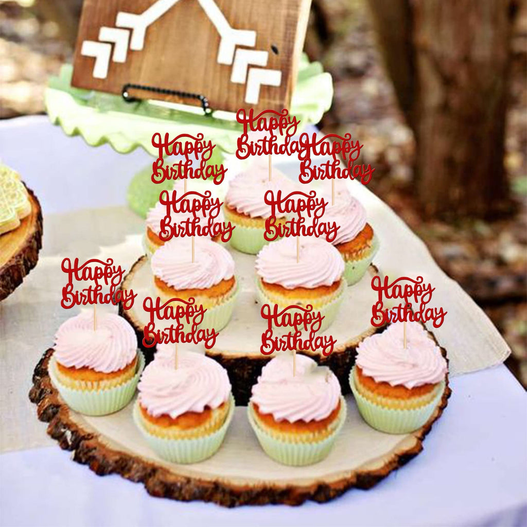 Red glitter 'Happy Birthday' cupcake toppers inserted into frosted cupcakes on a rustic wooden stand.