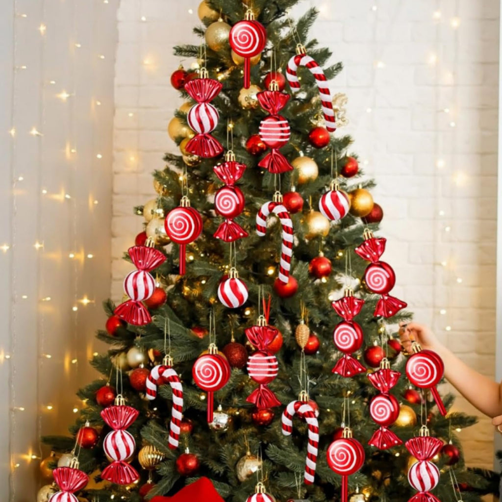 Christmas tree decorated with red and white shatterproof ornaments in ball, candy, and lollipop shapes.