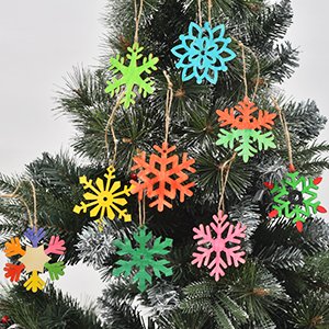 Assortment of 9 unfinished wooden snowflake ornaments in various colors hanging on a Christmas tree.