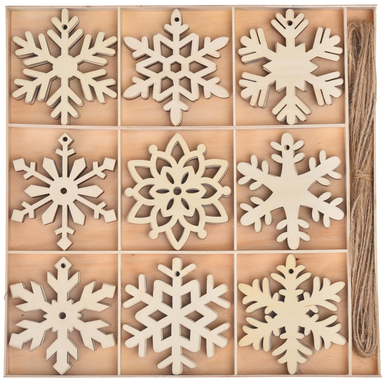 Unfinished wooden snowflake ornaments in a divided wooden box with jute rope on the side