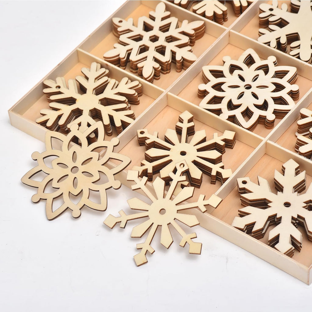 Unfinished wooden snowflake ornaments in a divided wooden box, close-up view
