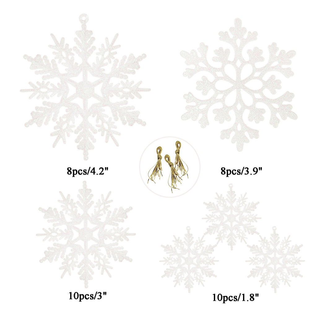 Four white glitter snowflake ornaments of different sizes and patterns, with gold hanging strings shown in a circle.