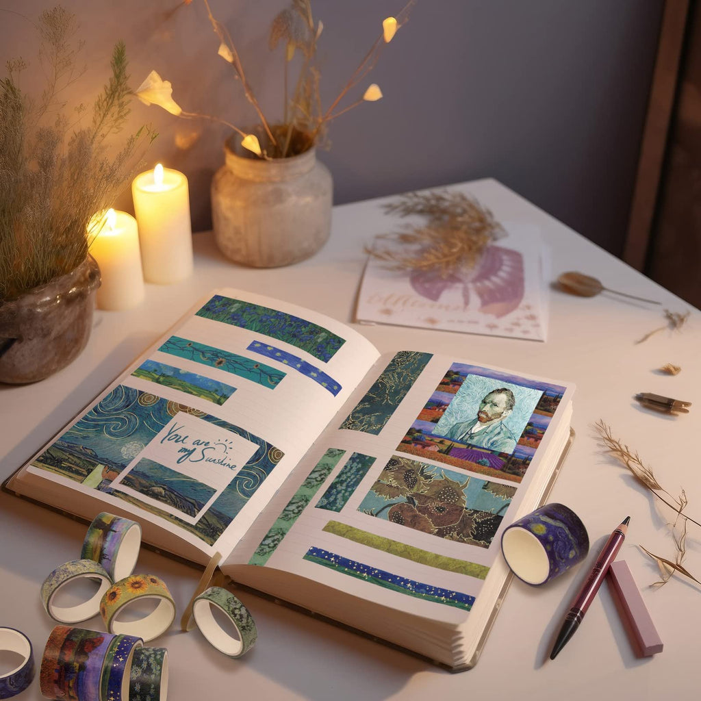 Open journal with various decorative tapes applied, featuring Van Gogh's self-portrait and sunflowers, surrounded by tape rolls and candles.