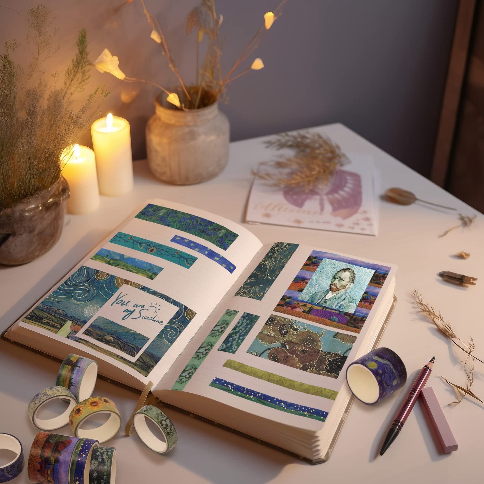 Open journal with various decorative tapes applied, featuring Van Gogh's self-portrait and sunflowers, surrounded by tape rolls and candles.