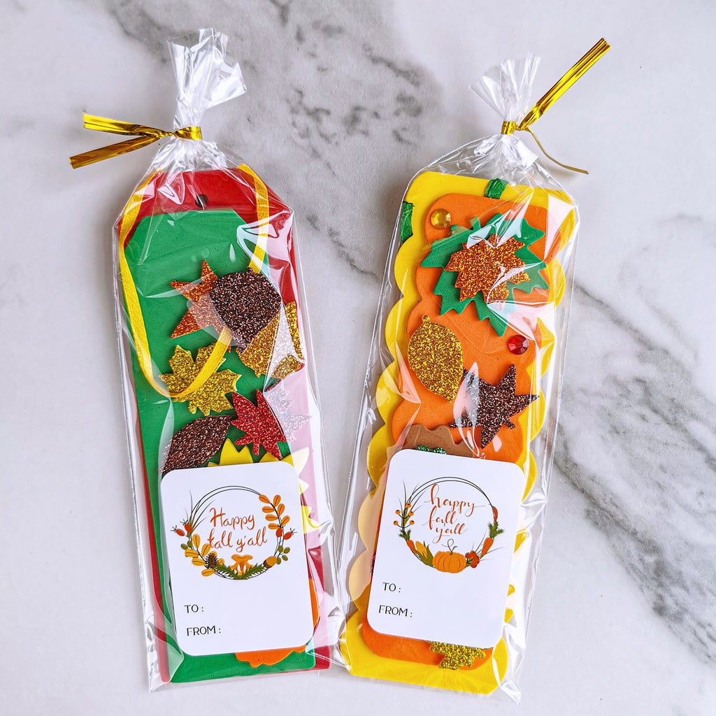 Two fall craft kits with glitter foam leaf and pumpkin shapes, each in a clear plastic bag with a gift tag.