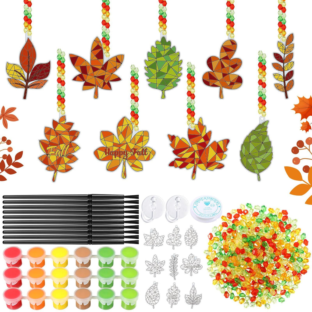 Autumn leaf suncatcher paint kit contents including paint pots, brushes, beads, and leaf frames.