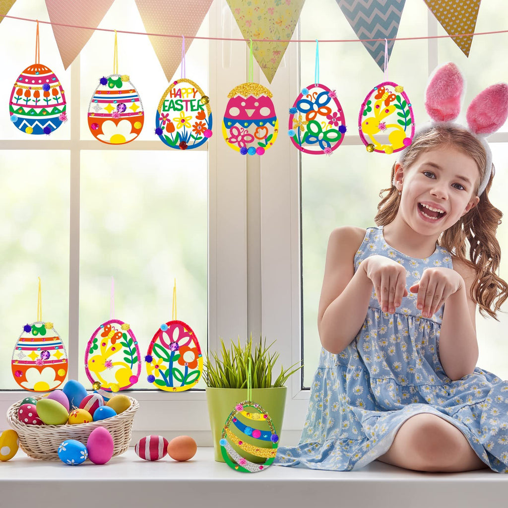 Girl with bunny ears smiling and posing with decorated Easter eggs hanging in a window