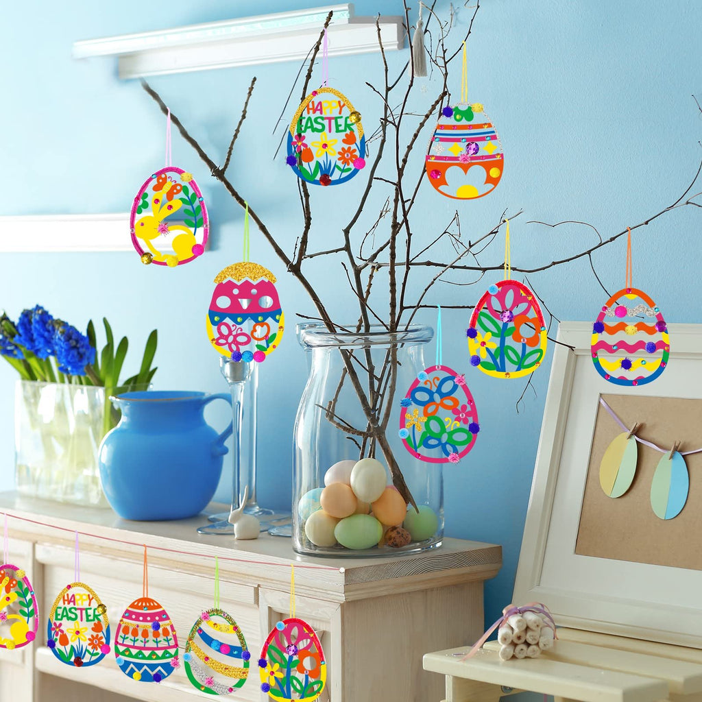 Easter egg ornaments hanging on branches, some with 'Happy Easter' text, decorated with glitter and pom-poms.