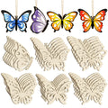 Four painted butterfly ornaments hanging and stacks of unfinished wooden butterfly cutouts