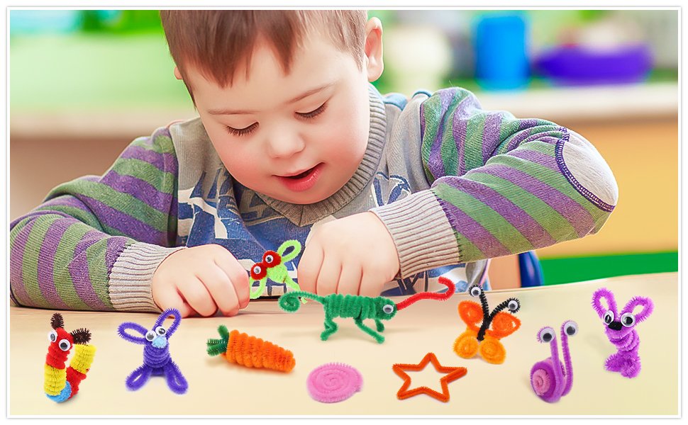 Young child with Down syndrome crafting pipe cleaner animals and shapes on a table