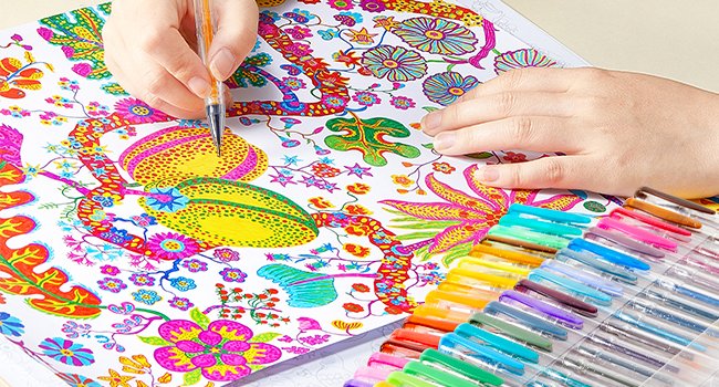 Hands coloring a detailed floral pattern with a set of colorful gel pens