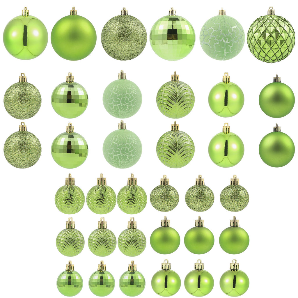 Collection of green Christmas ball ornaments in various sizes and styles, displayed on a white background.