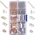Jewelry making kit with gold and silver chains, clasps, jump rings, and crimp ends in a clear organizer box.