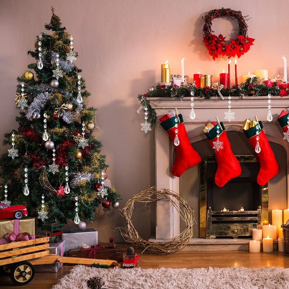 Christmas tree and fireplace decorated with clear snowflake and icicle ornaments, red stockings, and candles.