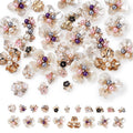 Assortment of floral flatback cabochons with pearls and rhinestones on white background