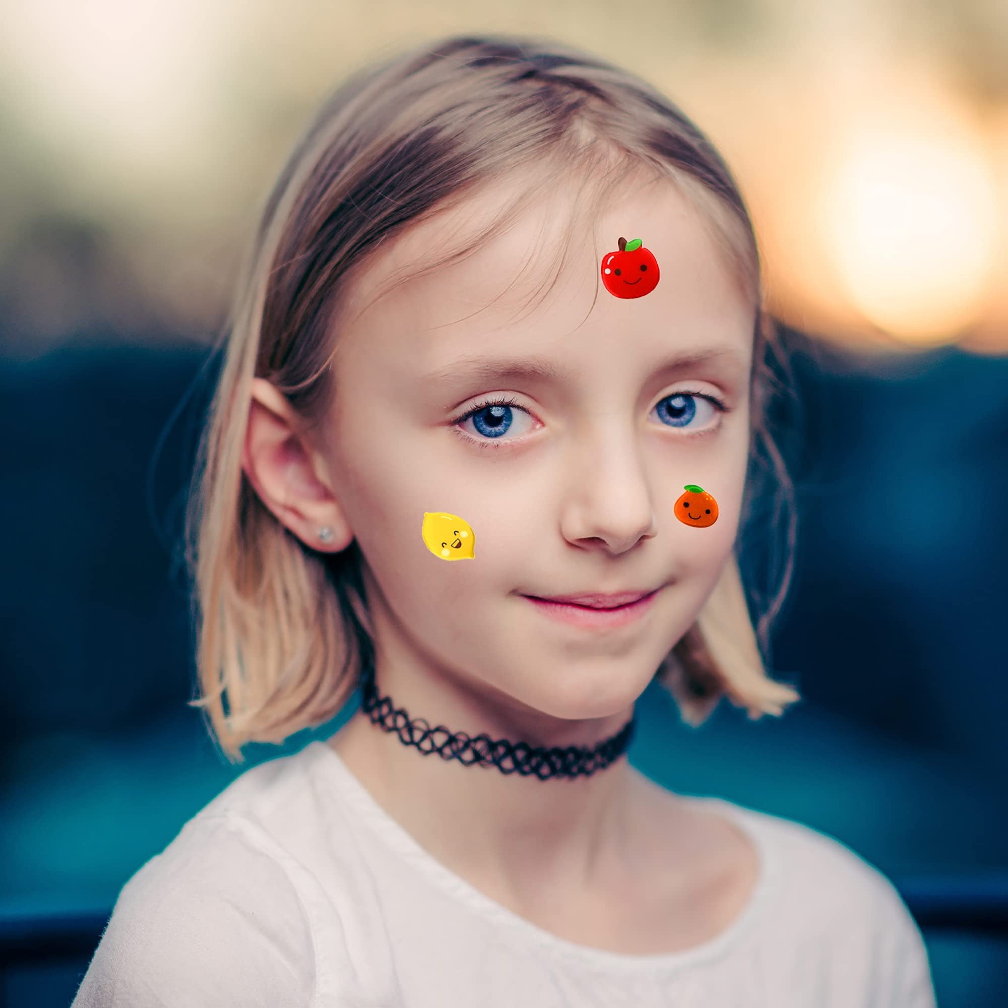Young girl with blue eyes and blonde hair wearing a white shirt and black choker, with puffy stickers on her face.