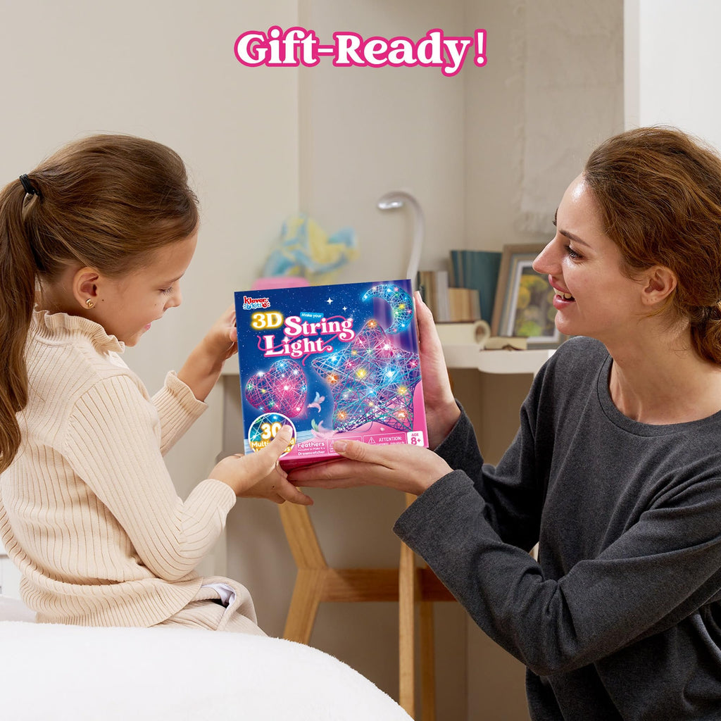 Mother and daughter holding a 3D String Light kit box with glowing heart, star, and moon shapes.