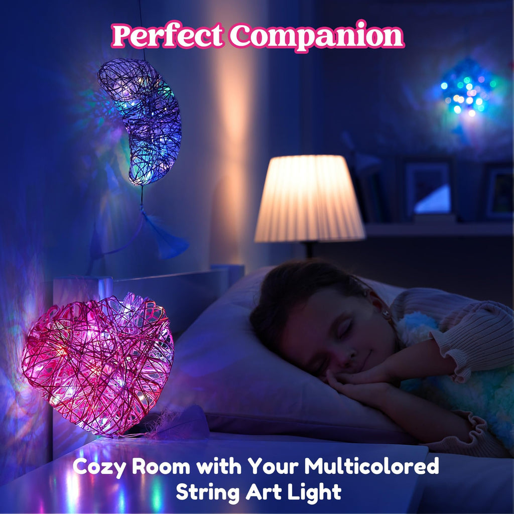 Child sleeping in bed with decorative string art lights casting colorful shadows on the wall.