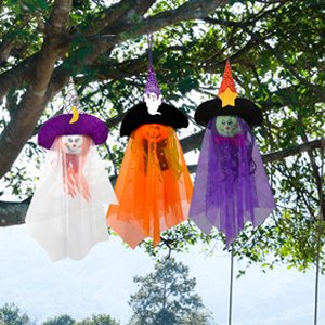 Three Halloween hanging ghost decorations with witch hats and faces, suspended from tree branches.