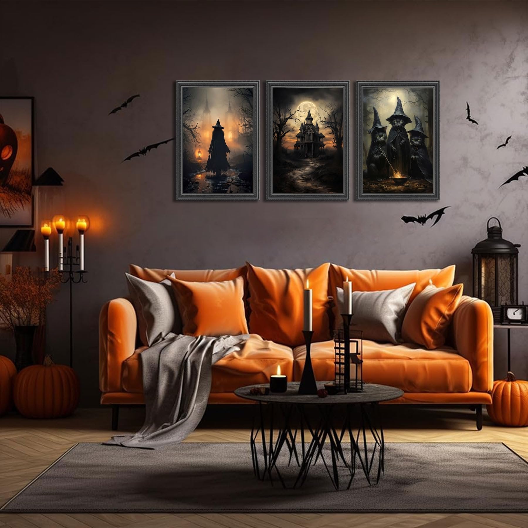 Three framed Halloween canvas art prints depicting witches and a haunted house, displayed above an orange sofa.