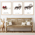 Three framed Christmas art prints depicting Santa Claus in a sleigh and reindeer pulling a sleigh, displayed above a wooden bench with festive pillows.