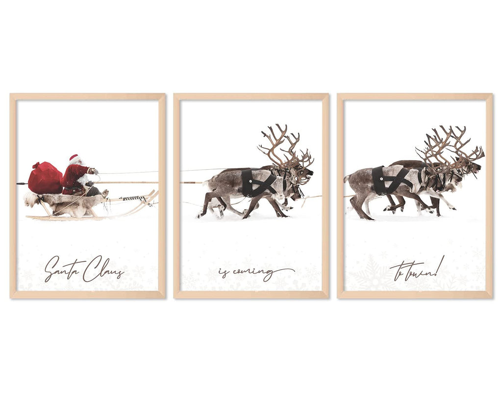 Three unframed Christmas art prints featuring Santa Claus in a sleigh pulled by reindeer, with text overlays.