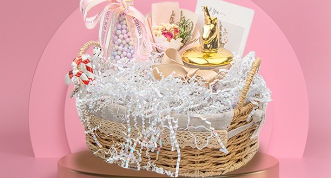 Gift basket filled with white crinkle cut paper shred, decorative ribbon, small bouquet, and gold horse figurine.