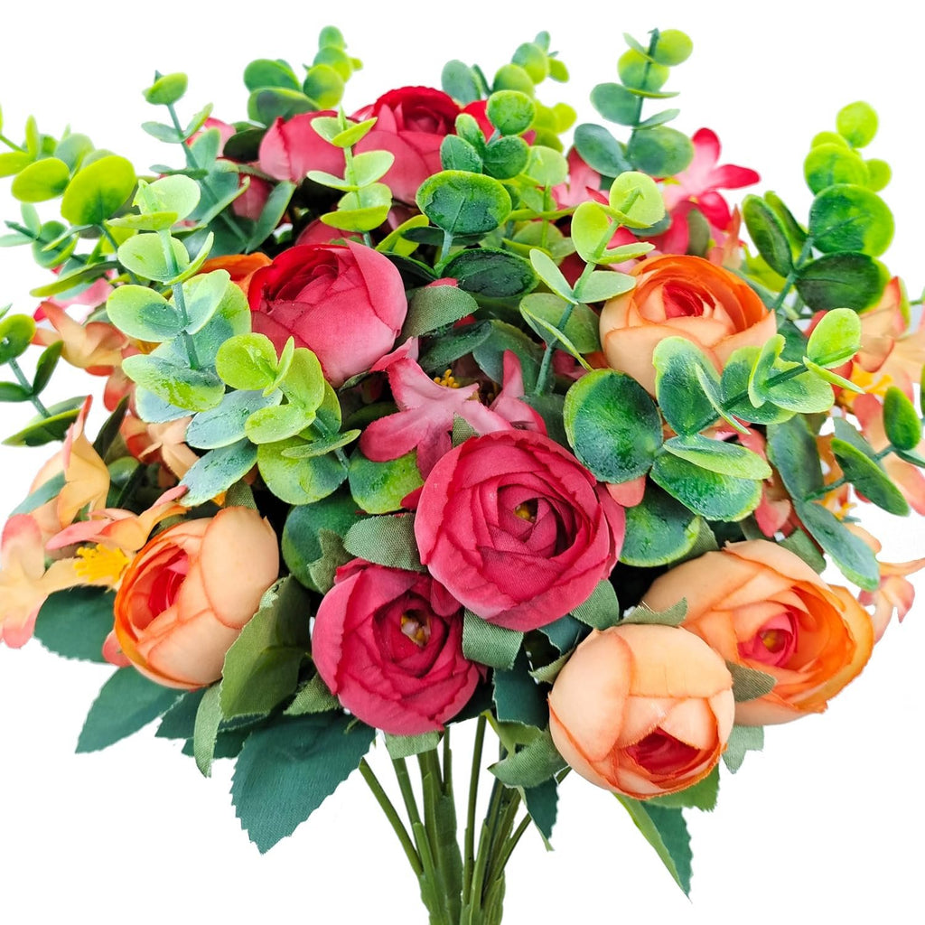 Artificial bouquet of red and orange roses with eucalyptus leaves on a white background