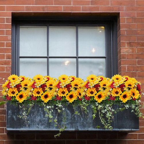 Faux sunflower and daisy floral arrangement in a window box planter