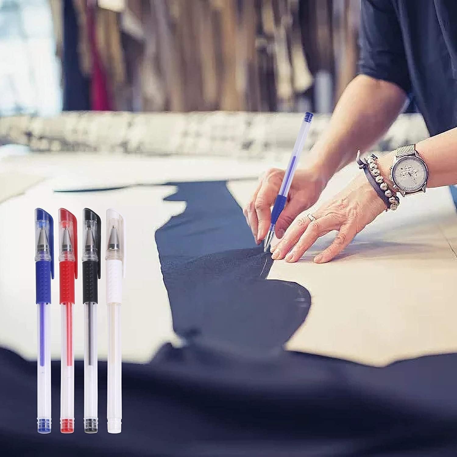 Four heat erasable fabric marking pens in blue, red, black, and white, laid out on fabric next to a pattern.
