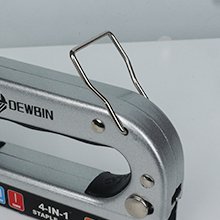 Close-up of a silver 4-in-1 manual staple gun with a wire handle and black grip.