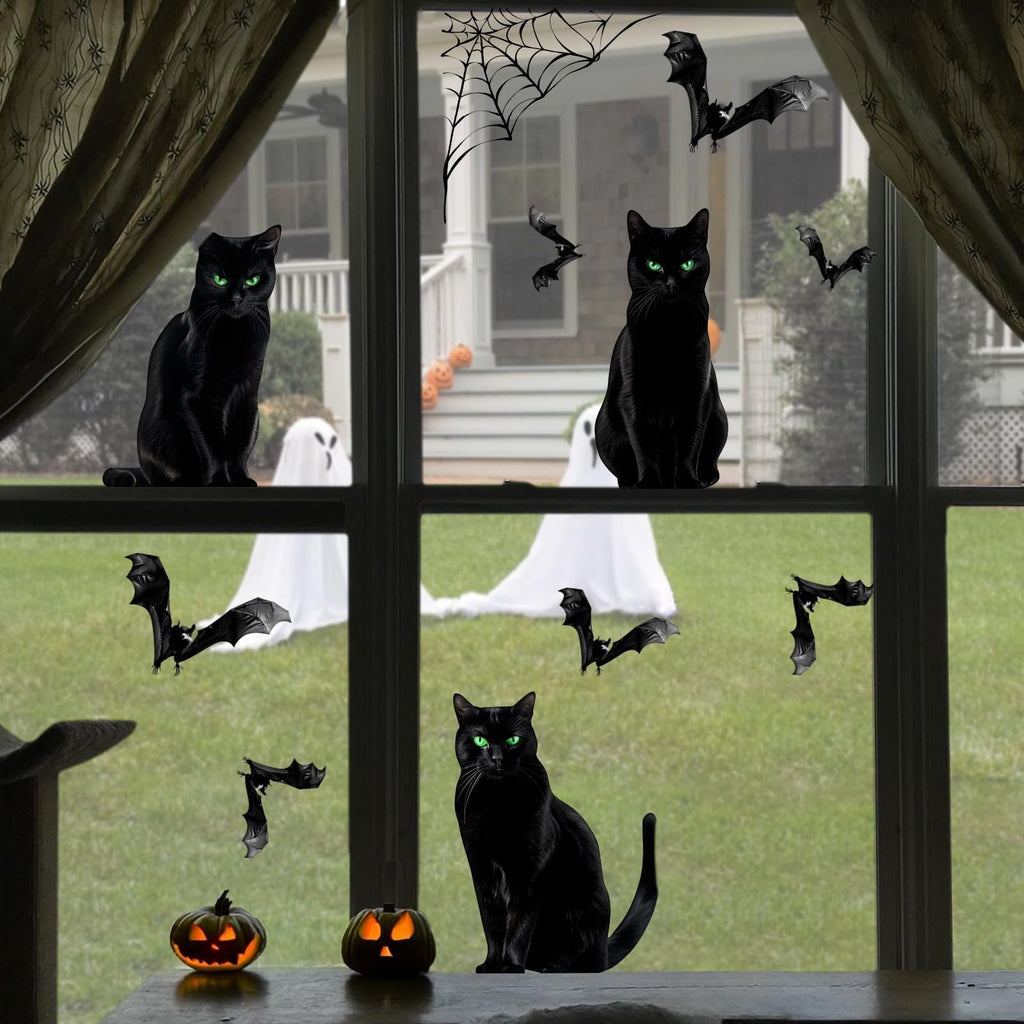 Black cat Halloween window clings with bats, spiderwebs, ghosts, and pumpkins on a window overlooking a yard.