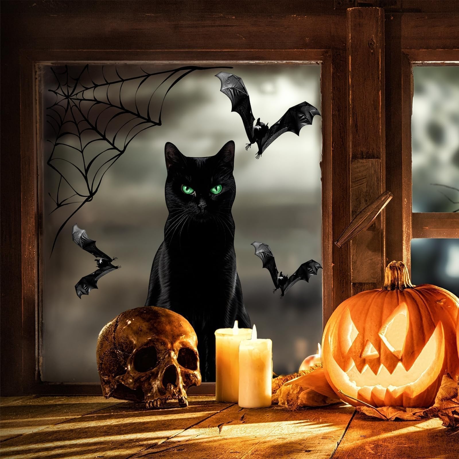 Halloween window scene with a black cat, bats, spiderweb, skull, candles, and a jack-o-lantern