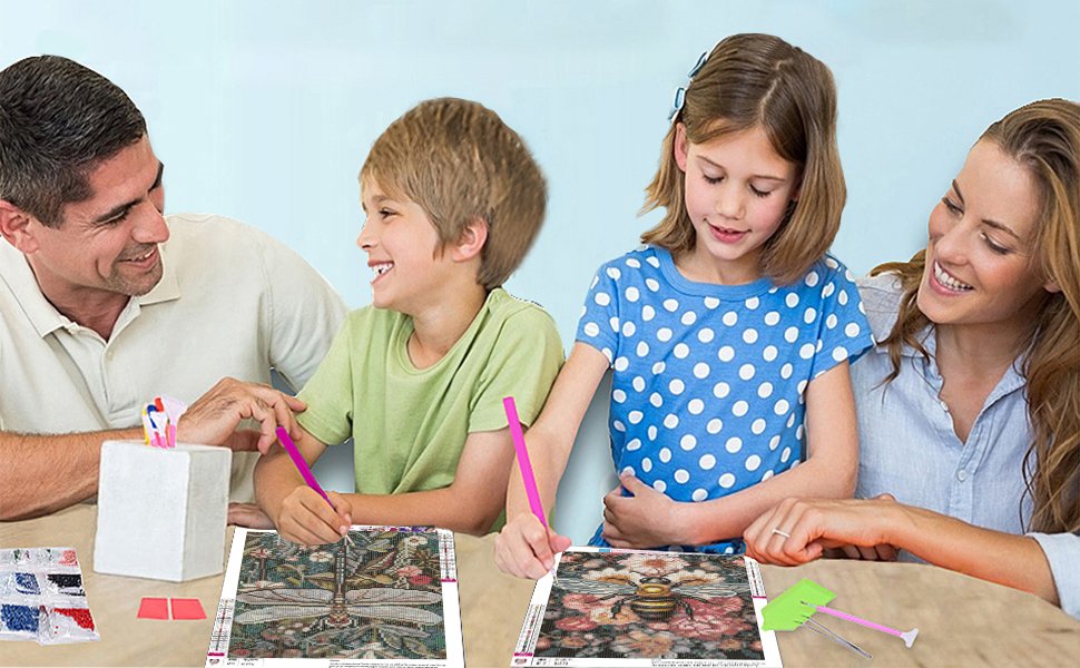 Family doing diamond painting kits at a table, featuring dragonfly and bee designs.