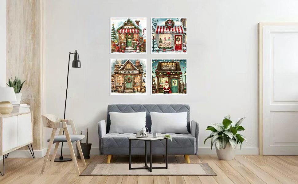 Four framed 5D diamond art paintings of Christmas shops displayed on a wall above a sofa.
