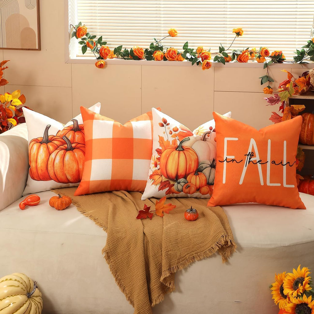 Four 18x18 inch fall-themed throw pillow covers arranged on a couch with a blanket.
