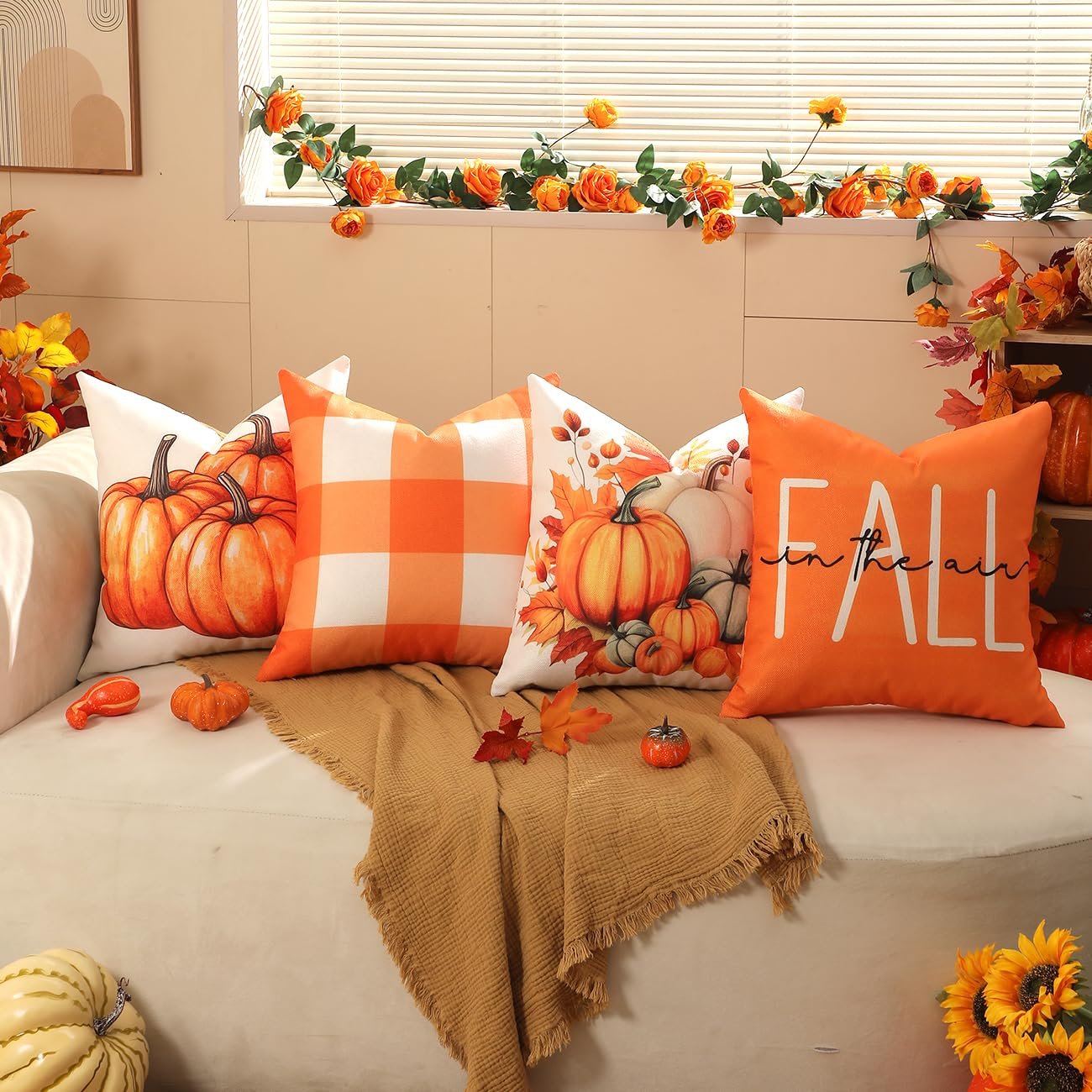 Four 18x18 inch fall-themed throw pillow covers arranged on a couch with a blanket.