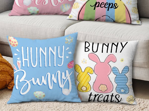 Four Easter-themed throw pillow covers displayed on a sofa, featuring bunny and egg designs with text.