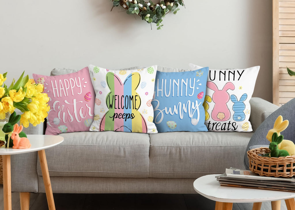 Four Easter-themed throw pillow covers displayed on a sofa, featuring bunnies and holiday text.