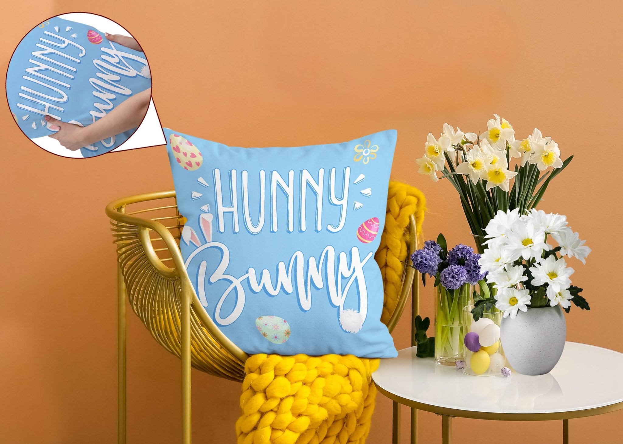 Light blue Easter pillow cover with 'Hunny Bunny' text and bunny ears, on a gold chair with yellow throw.
