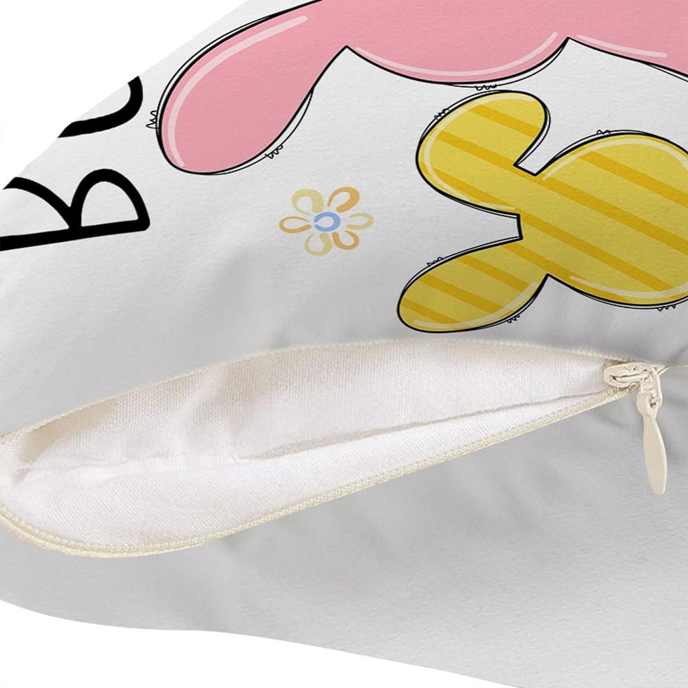 Close-up of a white pillow cover with a pink bunny ear and a yellow striped bunny ear graphic, showing a hidden zipper.