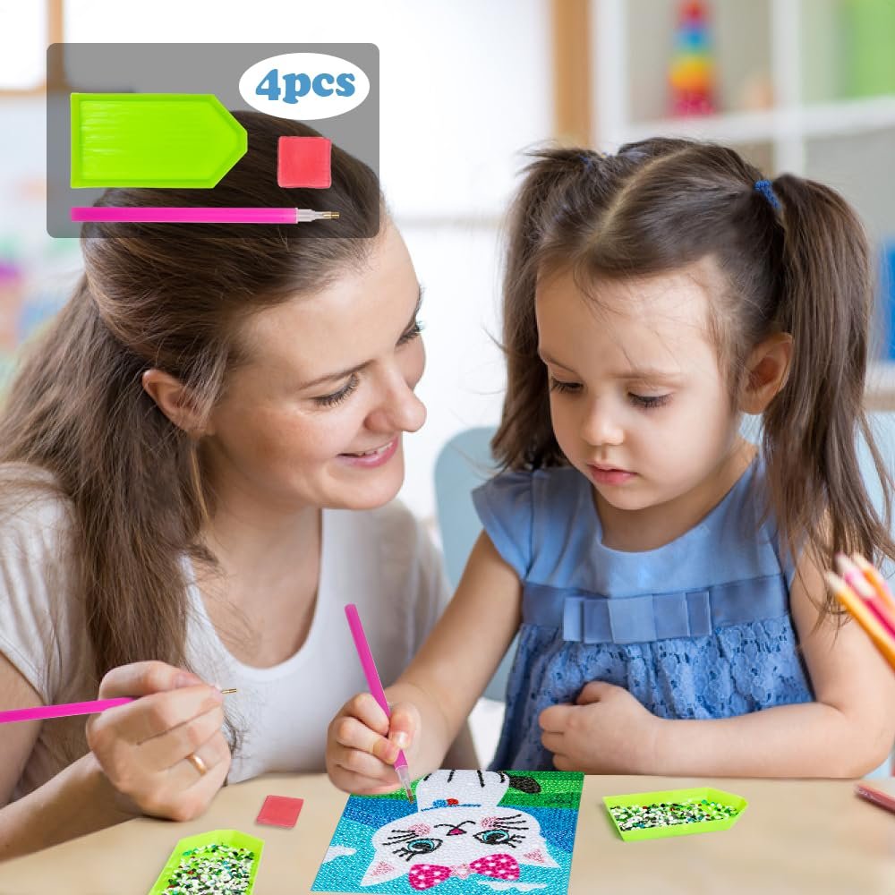 Woman and child doing diamond art kit with cat design, tools and gems on table