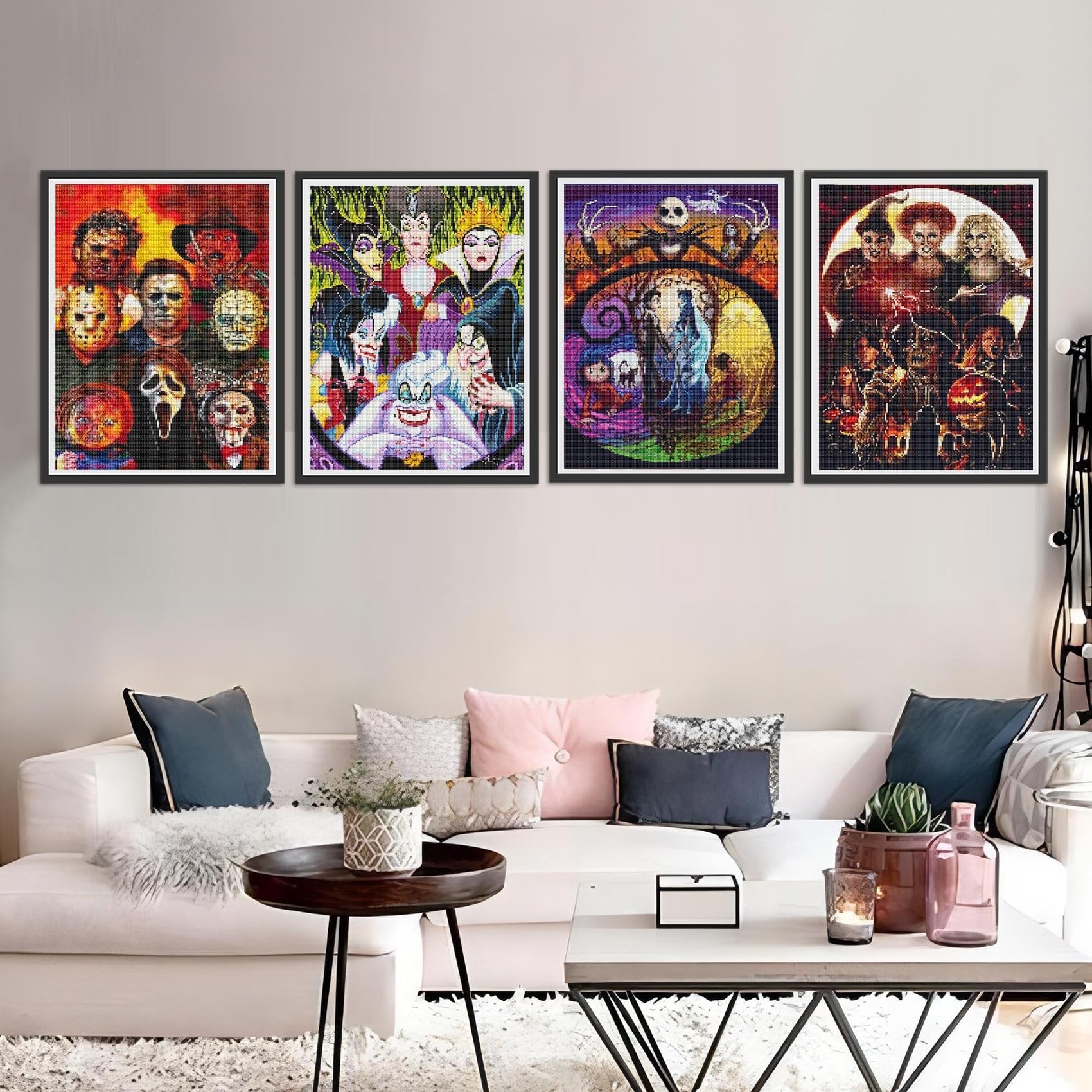 Four framed diamond art paintings of horror and Disney villains displayed on a wall above a sofa.