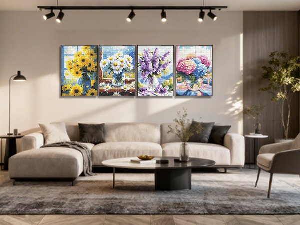 Four framed floral diamond paintings displayed on a living room wall above a sofa.