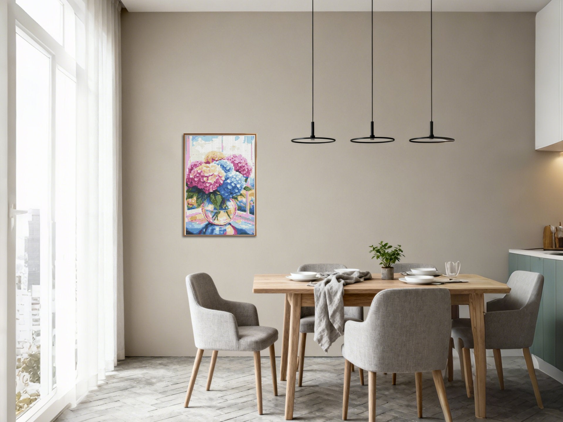 Diamond painting kit of colorful hydrangeas in a vase displayed on a dining room wall above a table.