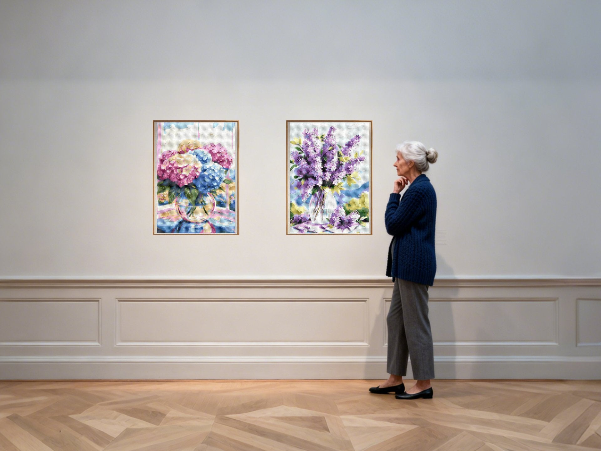 Woman admiring two framed diamond paintings of floral arrangements in a gallery setting