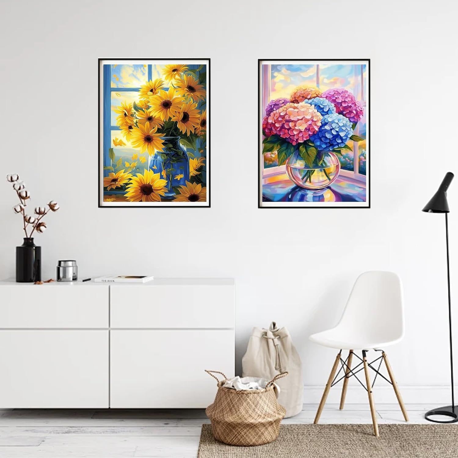 Two framed diamond paintings of floral arrangements on a wall, one with sunflowers, the other with hydrangeas.