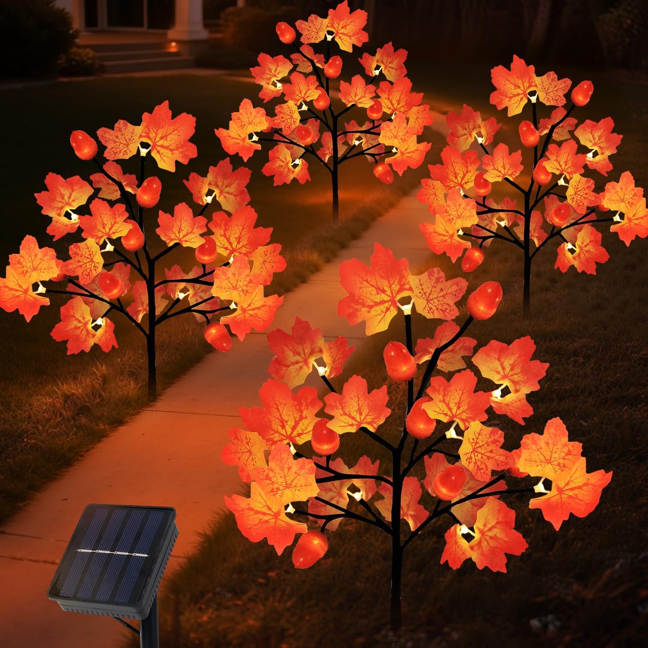Four illuminated solar maple leaf and acorn yard stake lights on a pathway at dusk